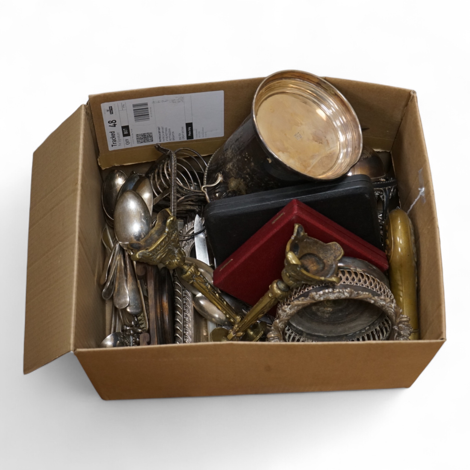 A group of assorted plated items including entree dishes, flatware and wine coaster.
